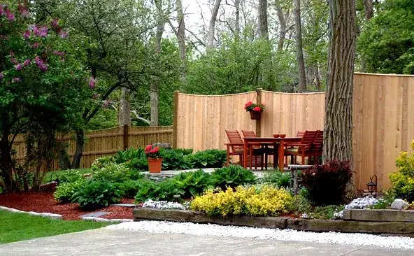 Scalloped cedar fence installed on a residential property on the South Shore
